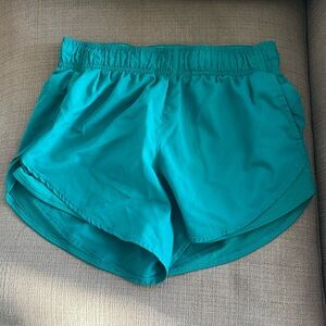 Green athletic shorts with lining and pockets